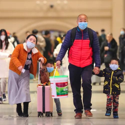 WUHAN, CHINA - JANUARY 21 2020: Passengers wearing protective masks walk inside Hankou Railway Station in Wuhan in central China's Hubei province Tuesday, Jan. 21, 2020. A new type of coronavirus has infected hundreds of people in the city.- PHOTOGRAPH BY Feature China / Barcroft Media (Photo credit should read Feature China / Barcroft Media via Getty Images)